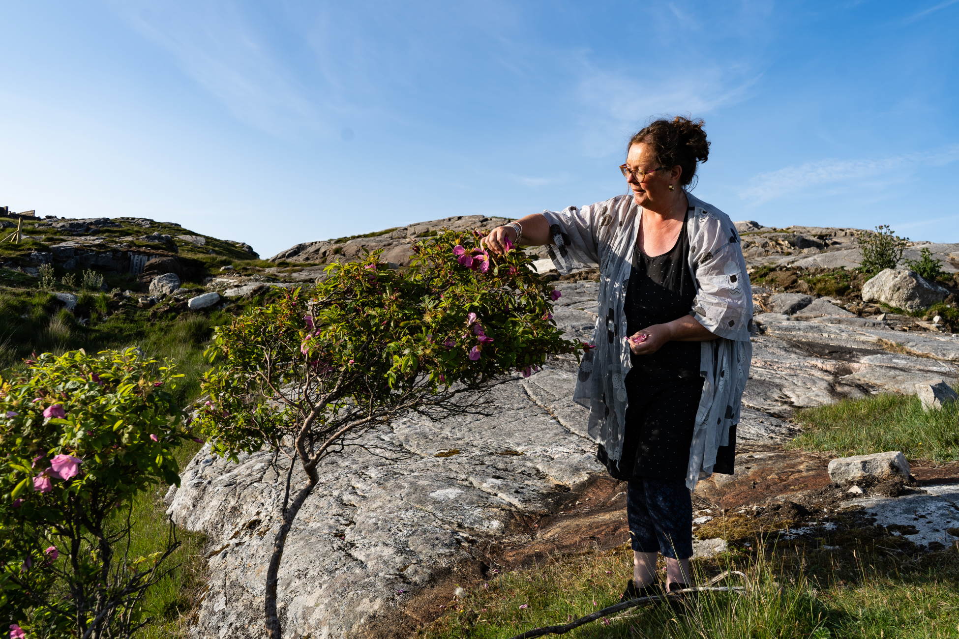 Owner of temple cafe Amanda Saurin picking wild produce