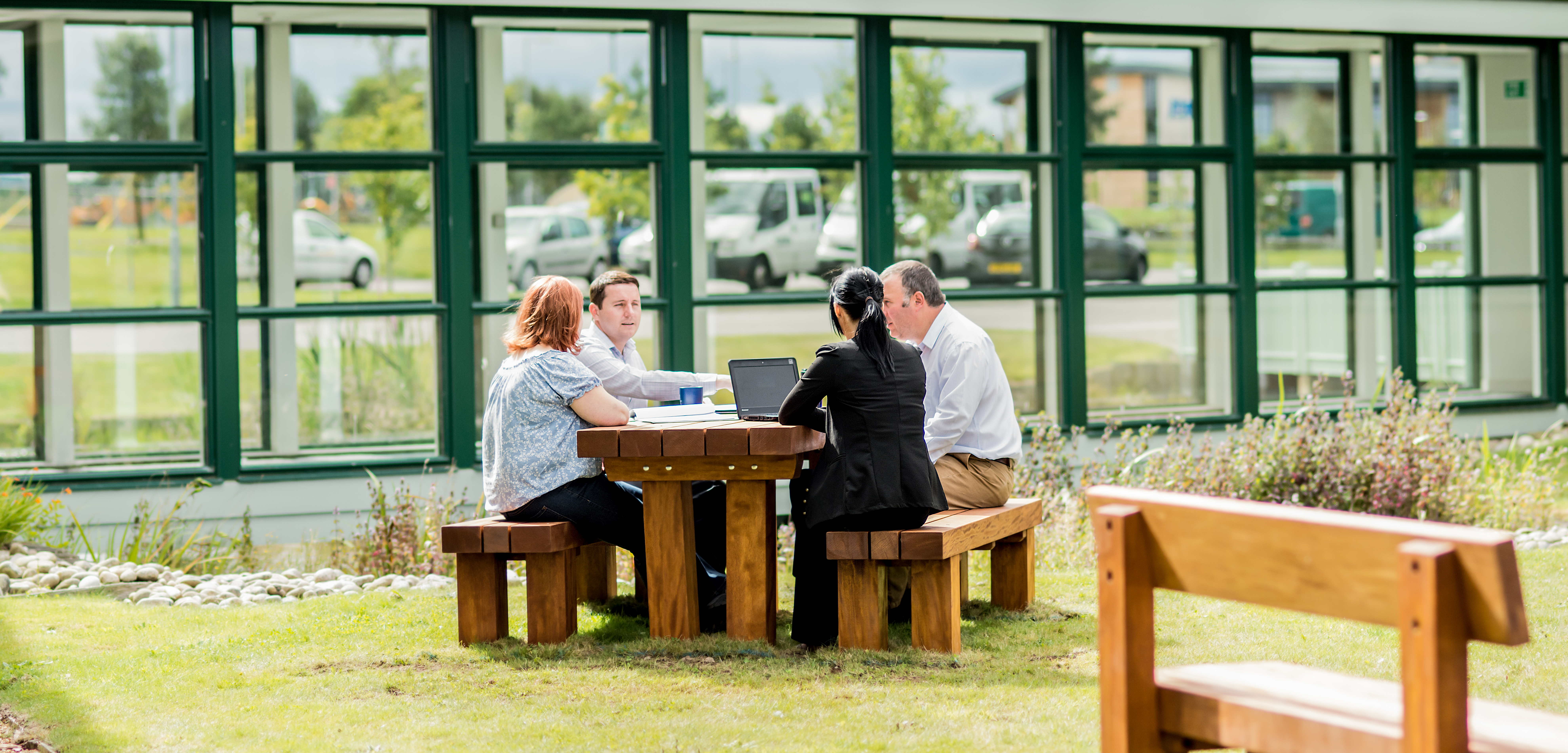 Colleagues using the tranquil shared outdoor space at Horizon Scotland, HIE's Moray office 
