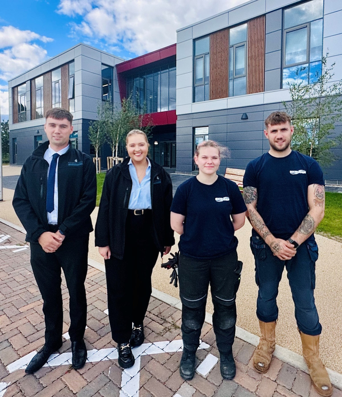 Four young workers at LSIC in front of the building