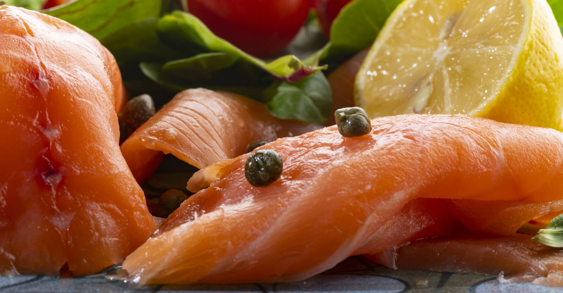 Smoked salmon presented with salad and pepper corns