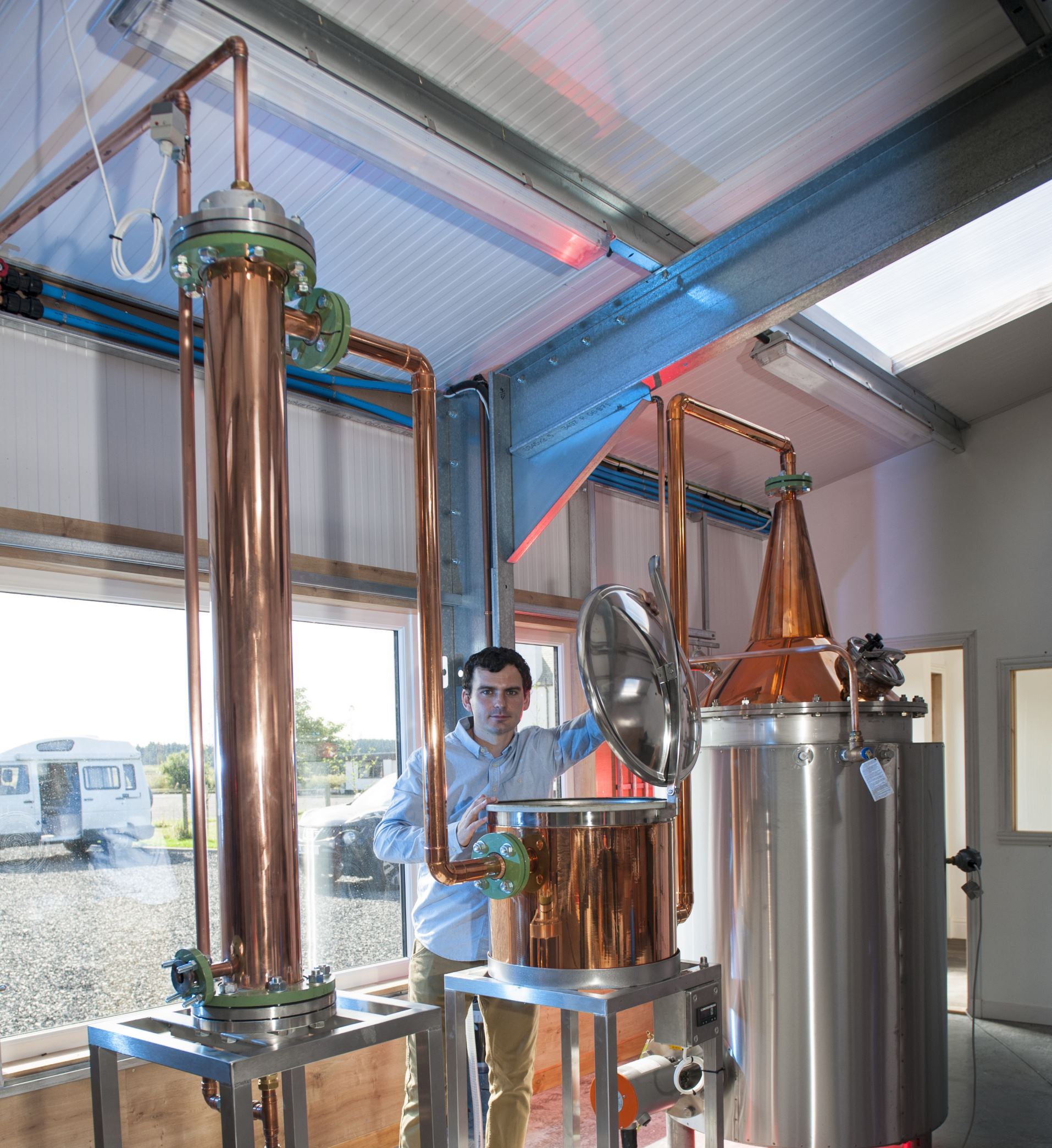 man standing by gin still