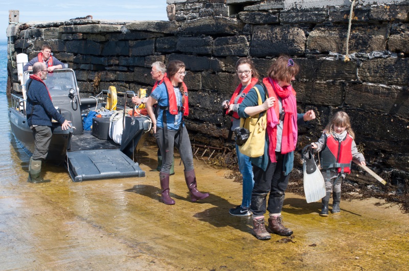 people disembarking small passenger ferry in Orkney