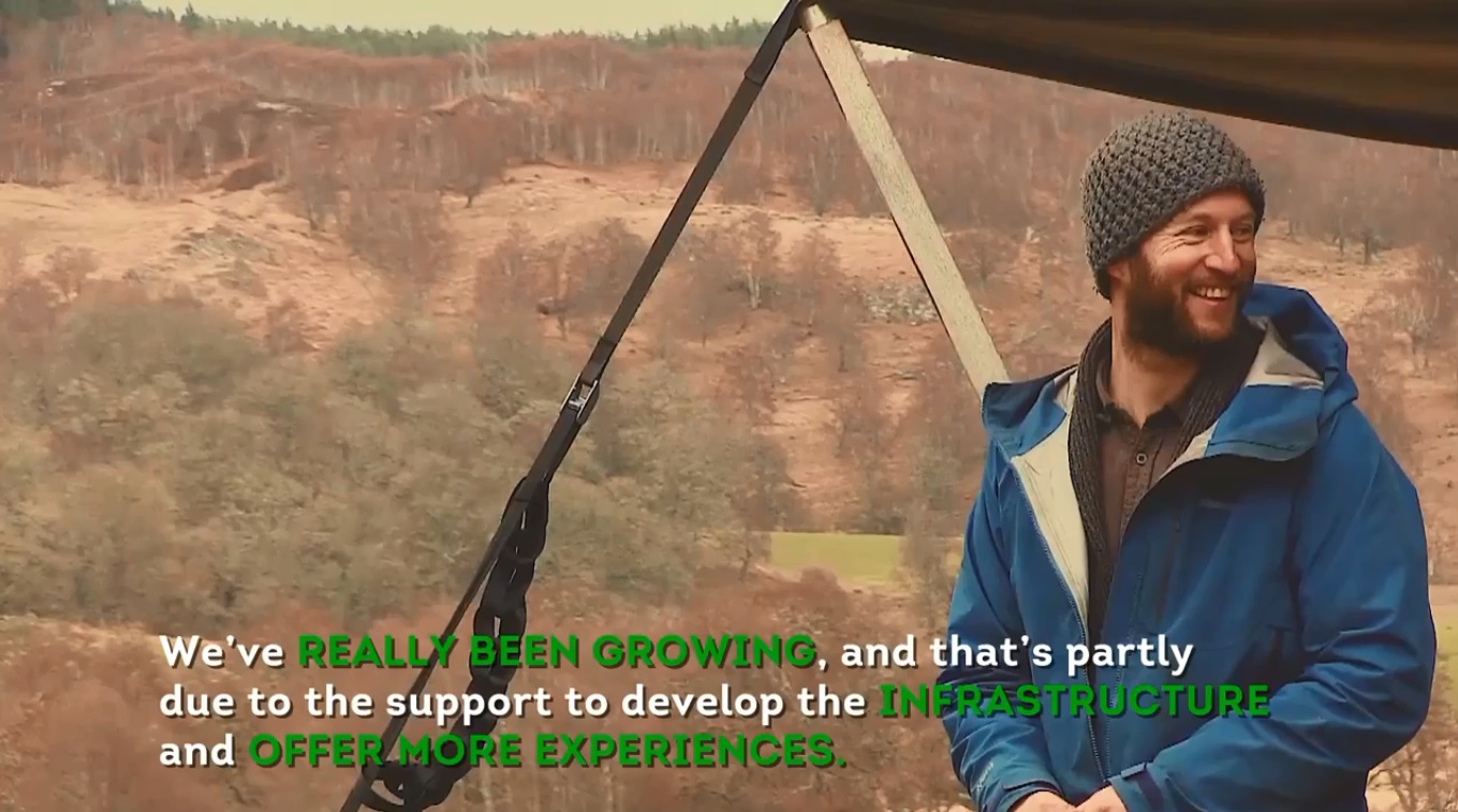 Dr Sam Harrison of the Shieling project standing in a treescape