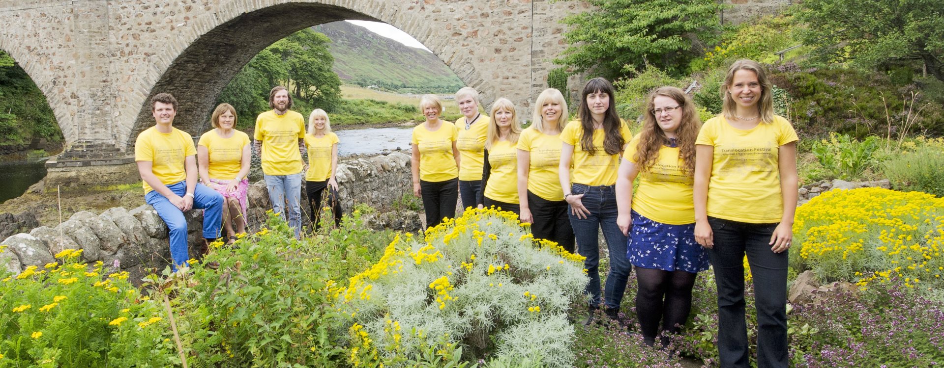 Timespan staff standing in front of bridge